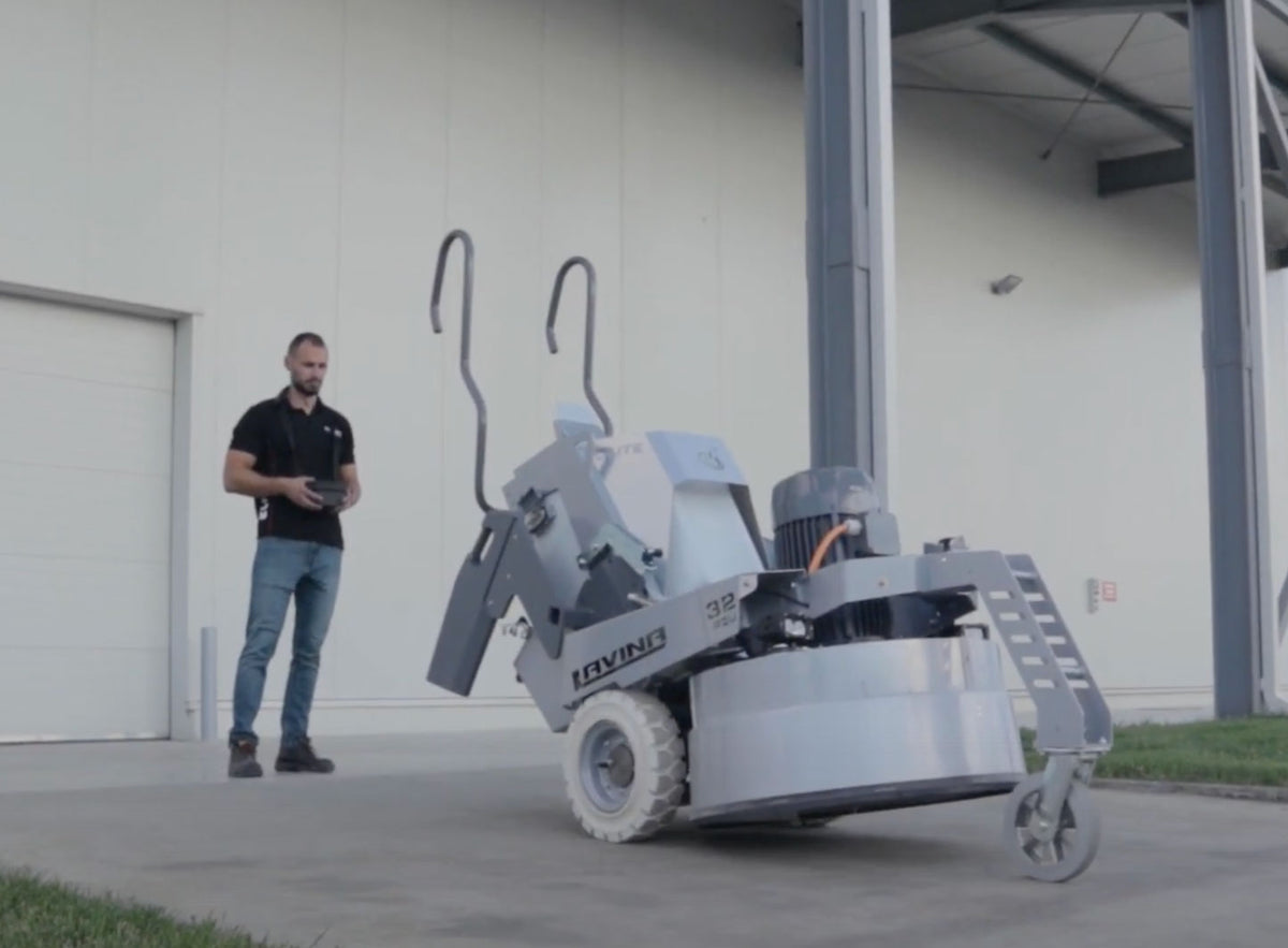 Lavina 32 Elite remote-controlled floor grinder running while the operator steers it with the remote
