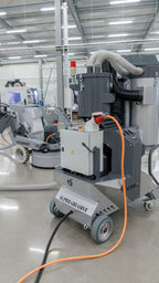 Lavina V32E electric dust extractor in use on a warehouse concrete floor polishing job