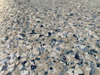 Close-up of a blue, tan and grey epoxy flake blend