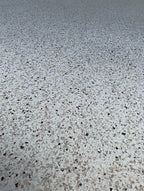 Close-up of a white, tan and brown epoxy flake floor