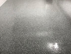 Grey epoxy flake floor with a glossy sheen